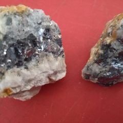 Galena, Lead Sulphide, (PbS), distinguished by very high density (7.5) and black, metallic lustre. Lead has been used for plumbing (hence the name!) since Roman times. Usage has decreased markedly in recent years, especially with the advent of lead free petrol.